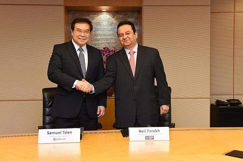 OCBC chief executive Samuel Tsien with National Australia Bank's general manager for Asia (ex-Greater China) Neil Parekh. OCBC's latest acquisition comes with a mortgage portfolio worth about US$1.7 billion of mainly residential mortgages, and a depo