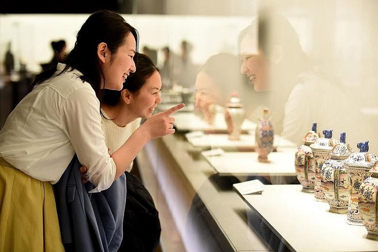 Employees of Suntory, a brewing and distilling group, visiting a museum after work on Feb 24, a Friday. Japan's Premium Friday scheme calls on bosses to let staff off at around 3pm on the last Friday of every month.
