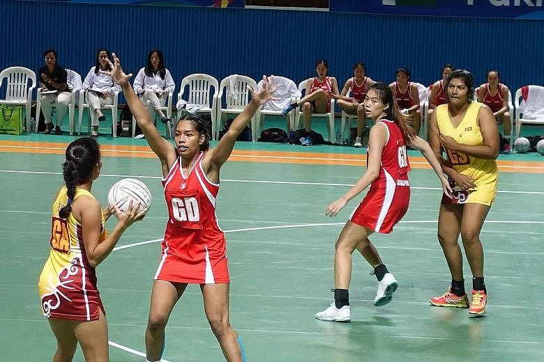 Singapore's Under-21 co-captain Aqilah Andin (above, second from left) defends during their Asian Youth Netball Championship's semi-final against Sri Lanka as team-mate Joanna Toh assesses the situation. Singapore won 58-32, and will face Malaysia in