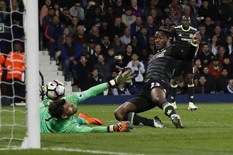 Chelsea's Michy Batshuayi slides in to prod the ball past West Brom 'keeper Ben Foster. Used sparingly this season, the Belgian scored what proved to be the winner in the Blues' 1-0 triumph, sealing the Premier League crown.