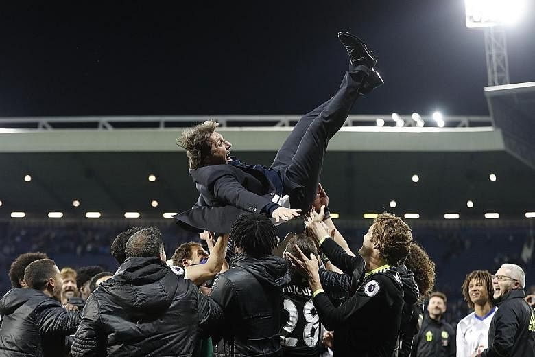 Jubilant Chelsea players throwing their manager Antonio Conte in the air after a 1-0 win over West Bromwich Albion on Friday night.