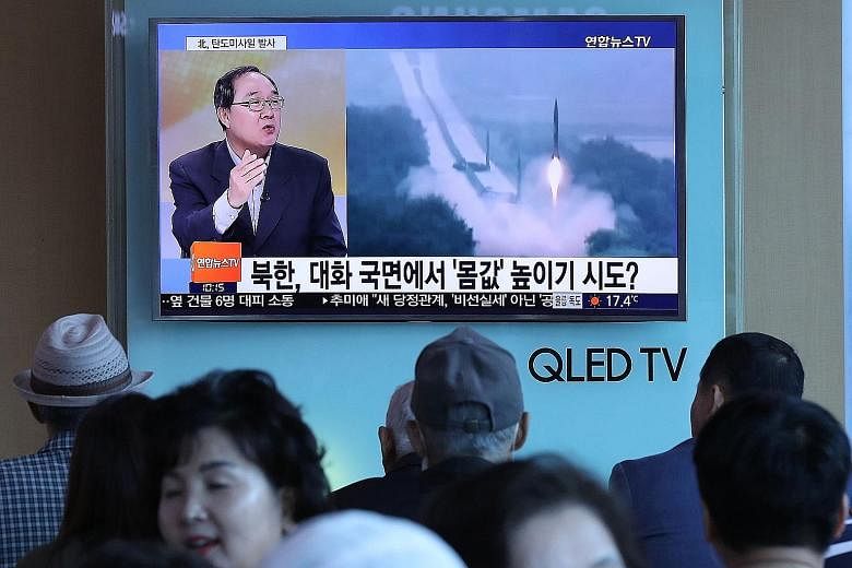 A news programme with file footage of a North Korean missile launch shown yesterday at a railway station in Seoul. The North fired a missile that landed in waters between North Korea and Japan yesterday.