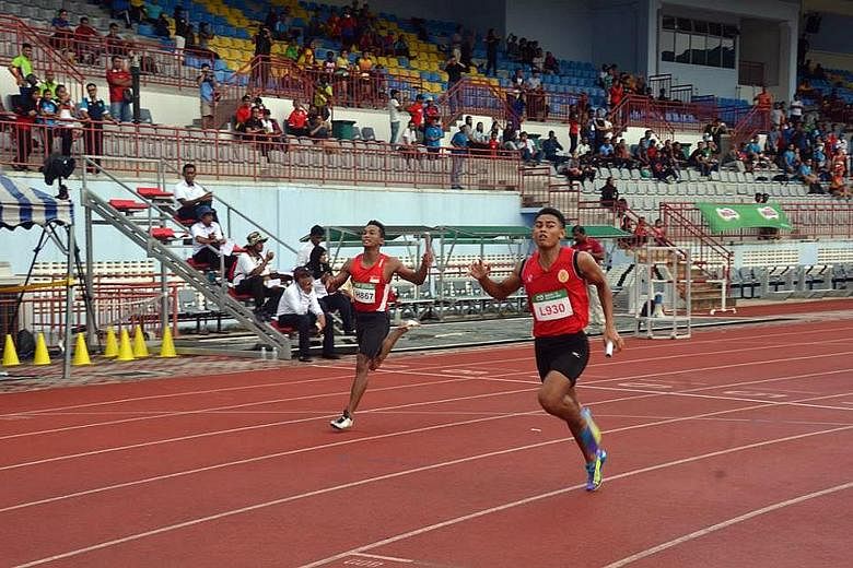 Singapore's Khairyll Amri following Tunku Mahkota Ismail Sports School's Muhammad Aiedel Saadon home in the 4x100m. The quartet need to clock 39.32sec to qualify for the SEA Games.