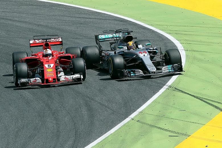 Mercedes' Lewis Hamilton being forced out by Ferrari's Sebastian Vettel as he tries to overtake. The soft tyres made the difference later in the race as the Briton won by 3.4 seconds.
