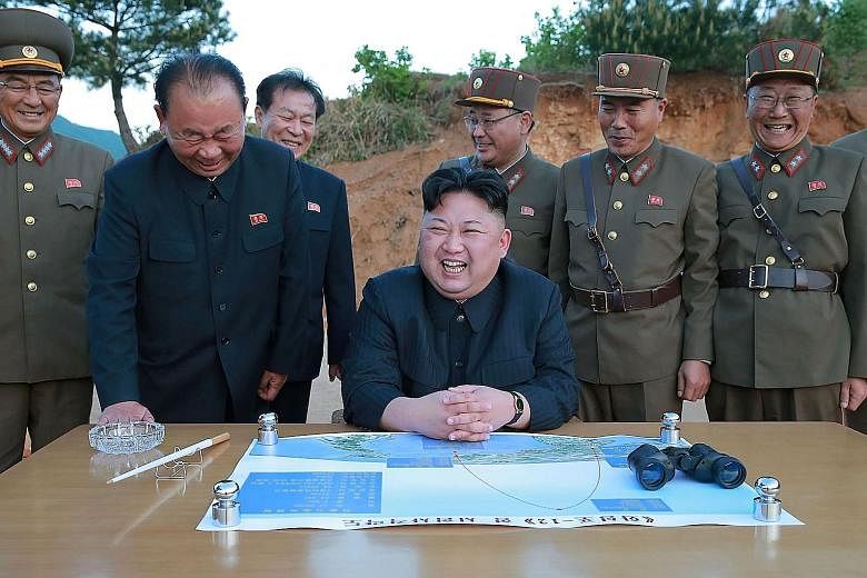 North Korean leader Kim Jong Un attending the test launch of a Hwasong-12 missile at an undisclosed location on Sunday.