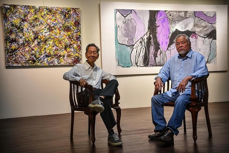 Choy Weng Yang (left) and Wong Keen in front of their pieces Radiant Lotuses and Lotus XX.