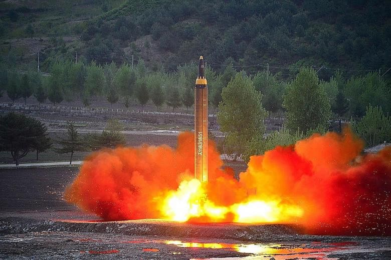 A photo released yesterday by North Korea's official news agency showing the test launch of new ground-to-ground missile Hwasong-12 at an undisclosed location.
