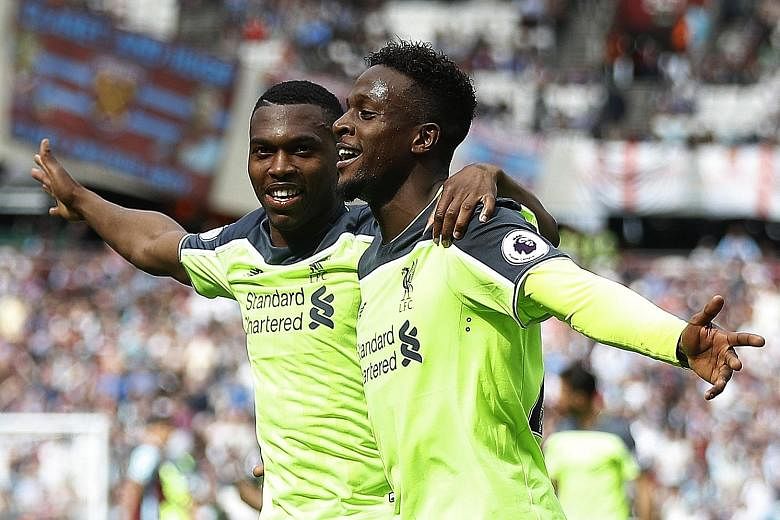 Liverpool's Divock Origi celebrates scoring their fourth goal against West Ham with Daniel Sturridge (far left), who himself netted the opener in a 4-0 win. The victory left Liverpool needing three more points to seal a top-four finish and qualificat