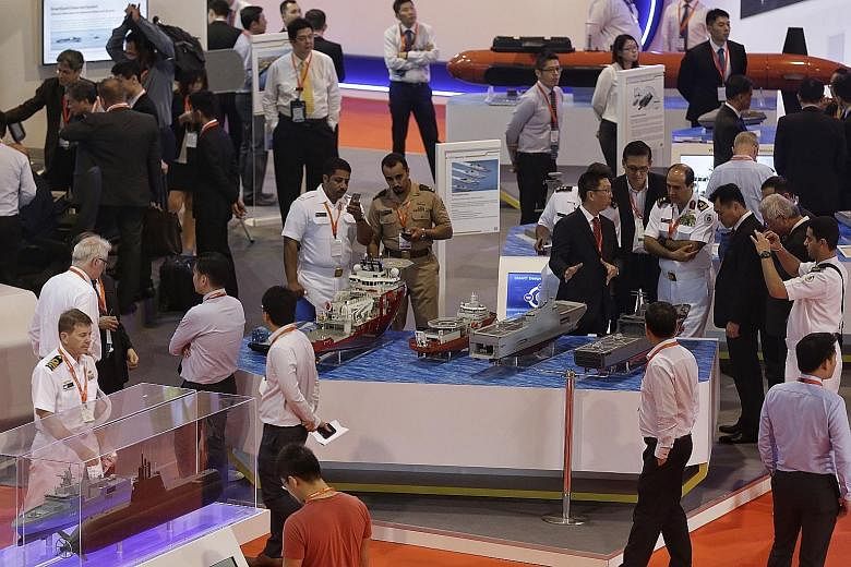 Visitors browsing the booths at the Imdex Asia defence trade fair at Changi Exhibition Centre yesterday.