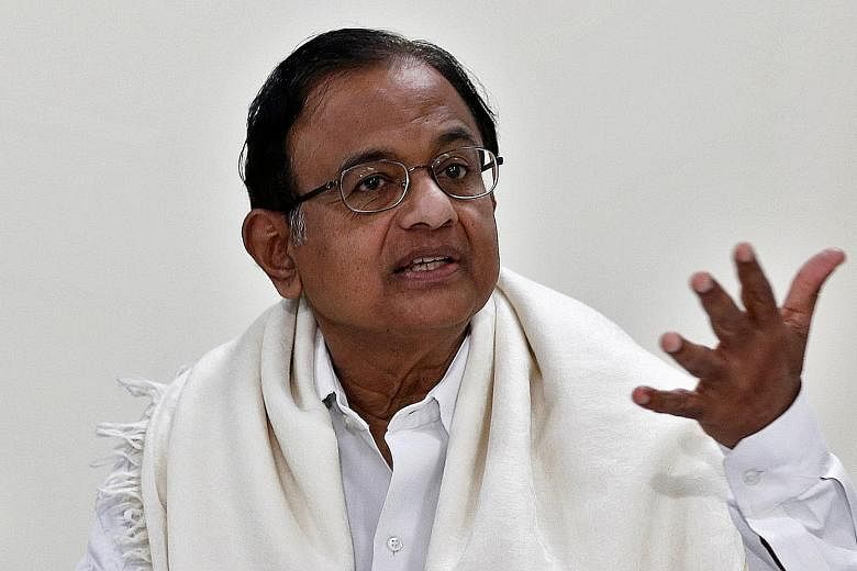 Mr Karti Chidambaram talking to the media after the Central Bureau of Investigation raided his house in Chennai yesterday. He and his father P. Chidambaram (below) are accused of criminal misconduct in granting approval for foreign investment deals, 