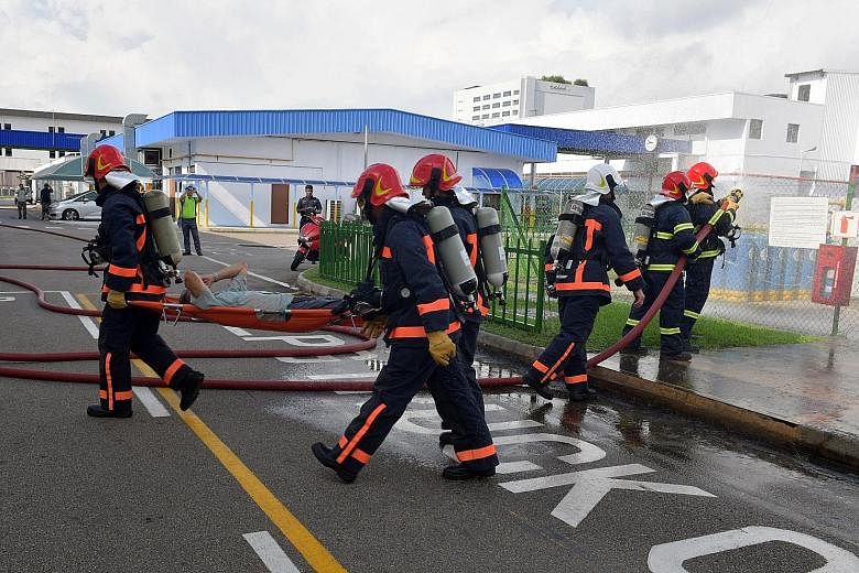 A "casualty" being evacuated from the premises of Panasonic Appliances Refrigeration Devices Singapore in Bedok South Road during yesterday's terrorism drill, which involved the in-house Company Emergency Response Team, police and the Singapore Civil
