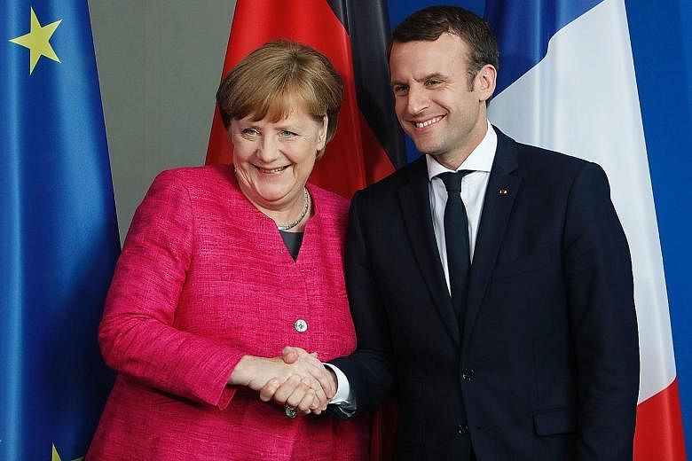 German Chancellor Angela Merkel and French President Emmanuel Macron at a press conference on Monday in Berlin. Mr Macron was on his first official trip abroad as president.