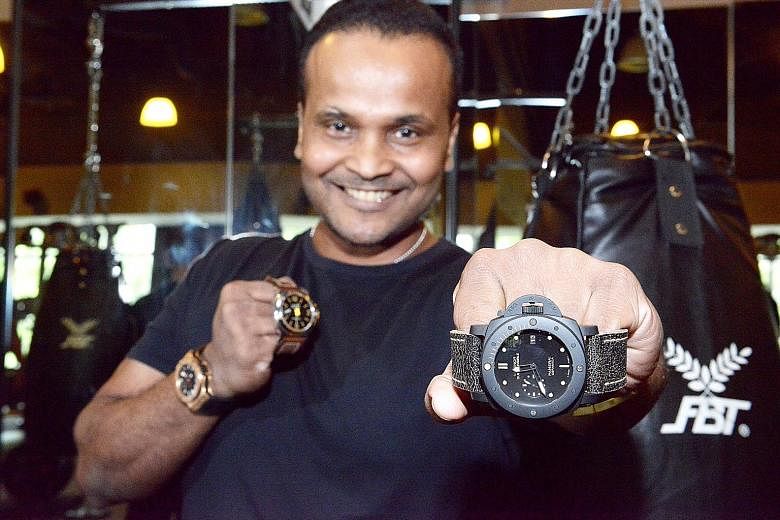Gym owner Mohamed Fazlon with three pieces he bought from pre-owned luxury watch dealers: (from left) Hublot Big Bang, Panerai PAM 1BT and Panerai PAM508. Mr Nick Lim, director of Chuan Watch at Golden Landmark, says his shop offers buy-back guarante