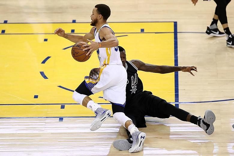 San Antonio's Dewayne Dedmon trying, but failing to stop Golden State's Stephen Curry driving past him. The Warriors guard was hard to handle on a night when he hit 15 points in 12 first-quarter minutes