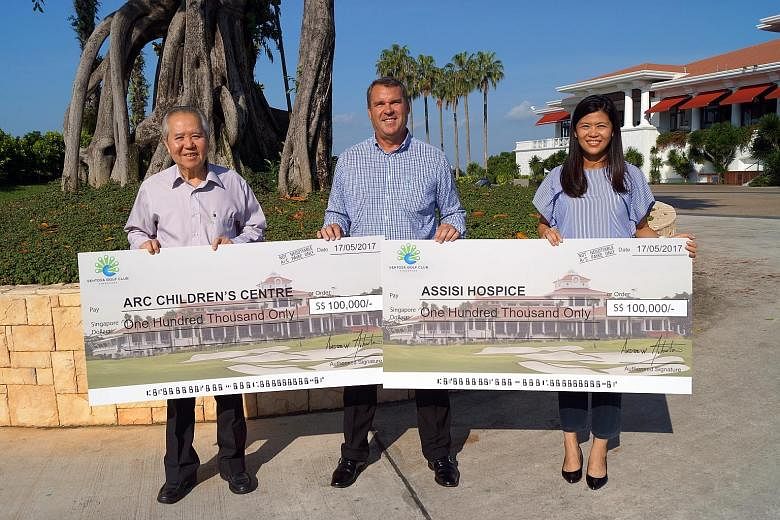 Arc Children's Centre board director Yeo Lee Hock (left) and Assisi Hospice's head of communications & community engagement Juliet Ng (right), with Sentosa Golf Club's (SGC) general manager Andrew Johnston at a cheque presentation ceremony yesterday.
