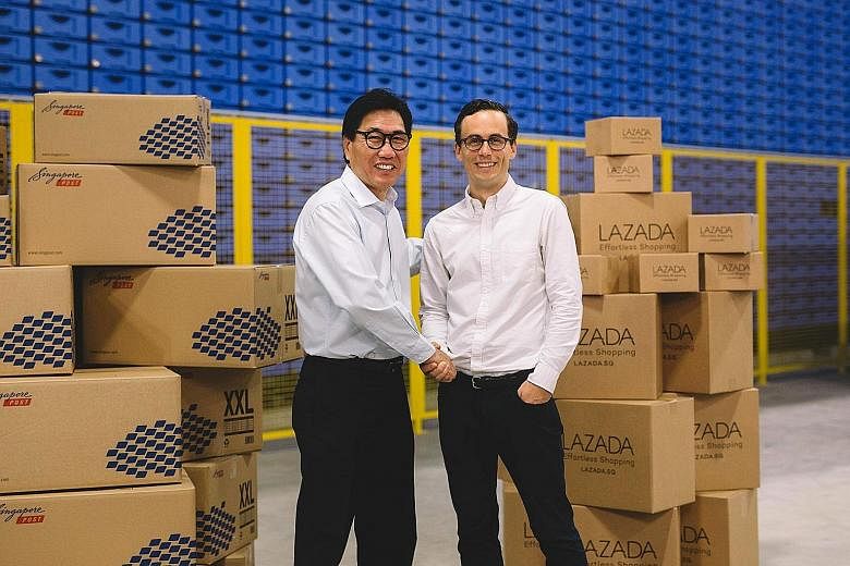 Mr Sam Ang, executive vice- president at SingPost, with Mr Alexis Lanternier, CEO of Lazada Singapore, in Lazada's new warehouse at the SingPost Regional eCommerce Logistics Hub in Tampines.