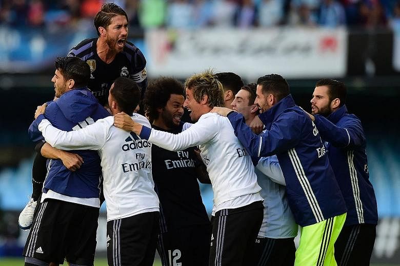 Real Madrid's Cristiano Ronaldo is swamped by his team-mates after scoring the opening goal in his side's 4-1 victory against Celta Vigo.
