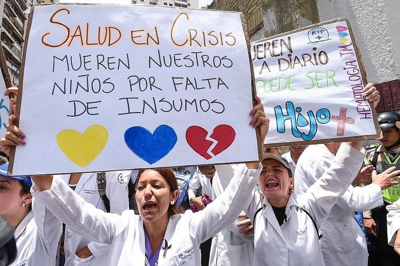 Doctors and other health workers in Venezuela protesting over the critical shortage of medicines during a demonstration in the capital Caracas on Wednesday.