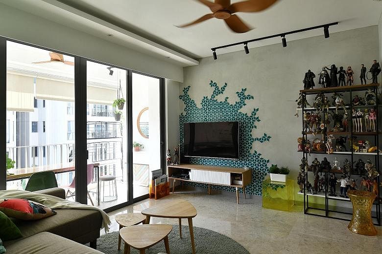 In the home of Mr Raymond Seow and Ms Chen Yifang (both above), feature walls are created using geometric shapes in pastel hues (left). Turquoise mosaic tiles are also used to create a pattern on a wall in the living room (right). The geometric-shape