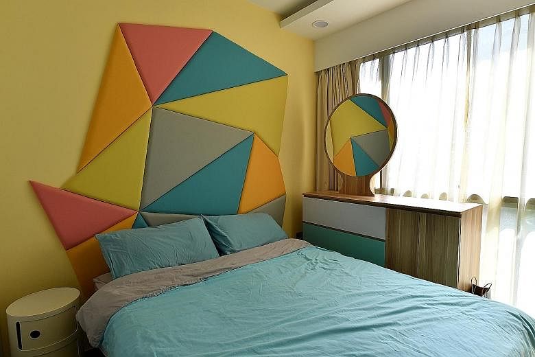 In the home of Mr Raymond Seow and Ms Chen Yifang (both above), feature walls are created using geometric shapes in pastel hues (left). Turquoise mosaic tiles are also used to create a pattern on a wall in the living room (right). The geometric-shape