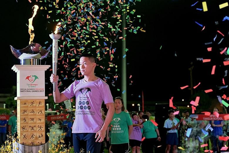 Special Olympics athlete Zaakir Rahmat (left) from Rainbow Centre Margaret Drive School was part of the Singapore contingent that attended yesterday's opening ceremony of the Special Olympics Singapore National Games. The ninth edition was officially