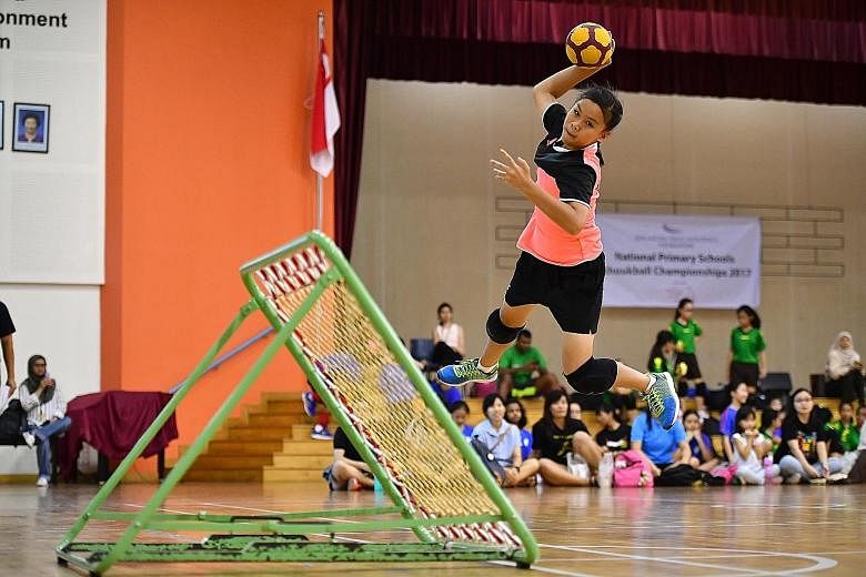 Greendale Primary School team captain Rachel Ong leaping in an attempt to score a goal. Her team beat Junyuan Primary School 11-8 on their opponents' turf to emerge champions in the Senior Division final of the SPH Foundation National Primary Schools