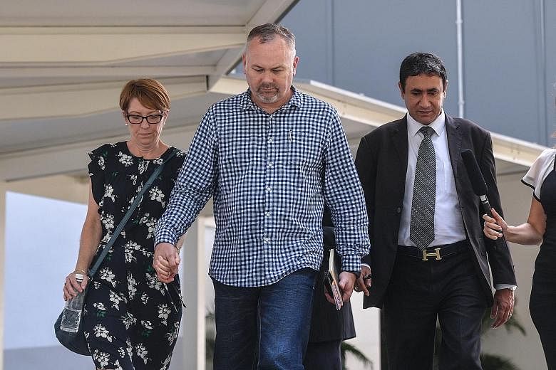 The sister and brother-in-law of Jason Peter Darragh leaving the State Courts with Darragh's lawyer S.S. Dhillon yesterday. Darragh will be back in court on June 8.