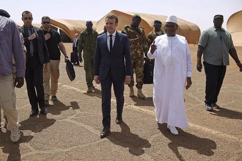 French President Emmanuel Macron and Mali's President Ibrahim Boubacar Keita visiting the Gao military base yesterday in northern Mali, where some 1,600 French troops are stationed as part of the counter-terror Operation Barkhane.