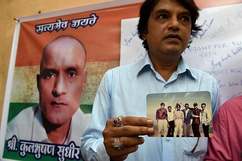 Former Indian naval officer Kulbhushan Sudhir Jadhav, whose image is on a banner here, has been accused by the Pakistani government of fomenting terrorist activities in the restive south-west province of Baluchistan, and sentenced to death. A friend 