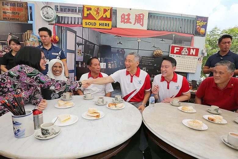 ABOVE: PM Lee Hsien Loong and Sengkang West MP Lam Pin Min (seated, second from right) with residents and grassroots leaders at the event yesterday. LEFT: The winning design for the facade of the new facility.