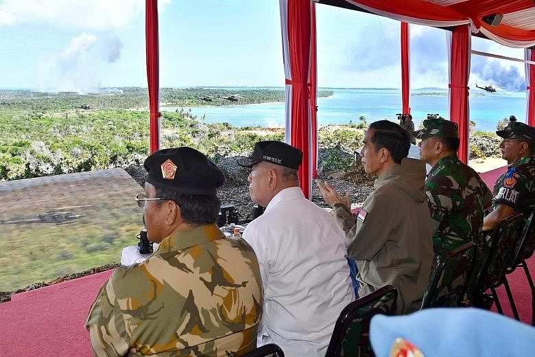 President Joko Widodo (third from left) and the top brass from the Indonesian military witnessing the show of force last Friday by the army, navy and air force in Tanjung Datuk on Bunguran Island, the main island of the resource-rich Natuna Islands.