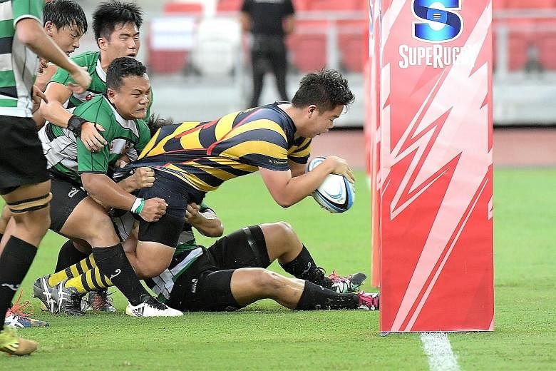 ACS (I)'s Benjamin Lim scoring his school's second try in the A Division rugby final. ACS (I) beat RI 12-3 in a repeat of last year's final.