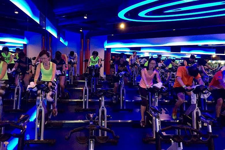 ST Run participants at a spinning class at True Fitness spin studio yesterday. The workout was accompanied by pumping music and lights.