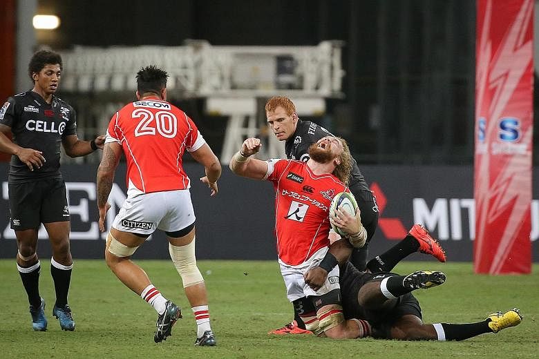 The Sunwolves' Willem Britz is tackled by Tendai Mtawarira of the Sharks in yesterday's Super Rugby encounter at the National Stadium. The score was tied at 7-7 in the 19th minute before the visitors took control of the game to win 38-17.