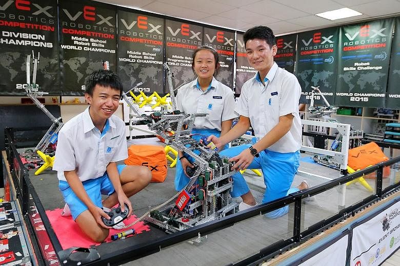 The team from Hai Sing Catholic School, comprising (from left) Sam Andrew Sy, Shannon Chua and Ernest Tan Jun Yi, rebuilt their robot Atom-U at least 10 times in preparation for the VEX Robotics World Championship, in which they triumphed in the midd
