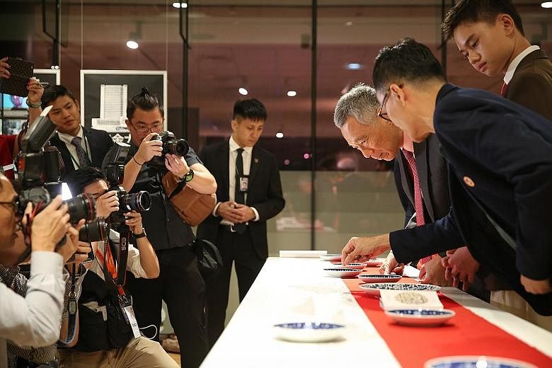 Prime Minister Lee Hsien Loong looking at artist Edwin Low's painting Shan Shui during the opening of the Singapore Chinese Cultural Centre. The centre is a platform that showcases local Chinese arts and culture.