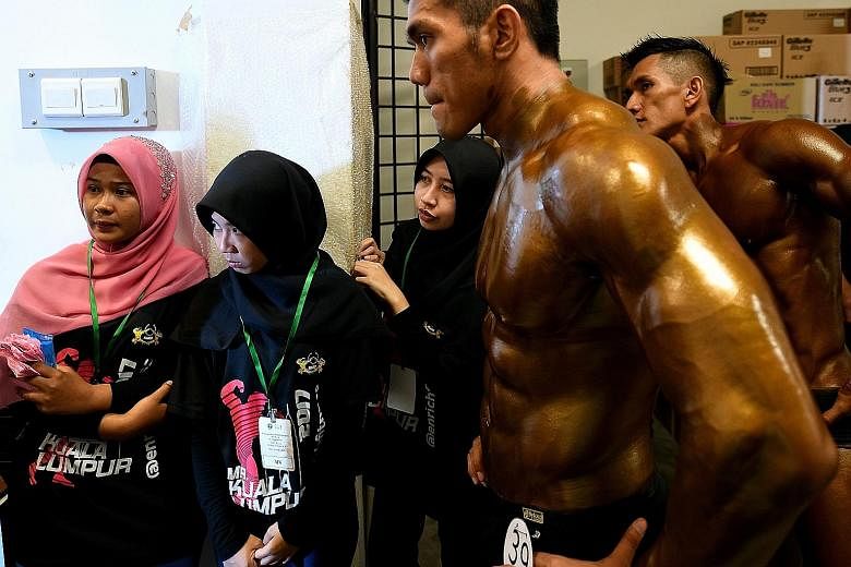 Contestants waiting backstage at the Mr Malaysia bodybuilding competition in Puchong, outside Kuala Lumpur, on Sunday. The majority of the 70 finalists were ethnic Malay Muslims. Malaysia is generally regarded as a moderate Muslim country, but fears 