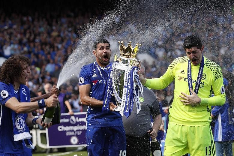 Above: Chelsea's Diego Costa and Thibaut Courtois (right) are sprayed with champagne by team-mate David Luiz during the festivities after their 5-1 win over Sunderland. Left: John Terry gets a guard of honour after his premeditated substitution in th