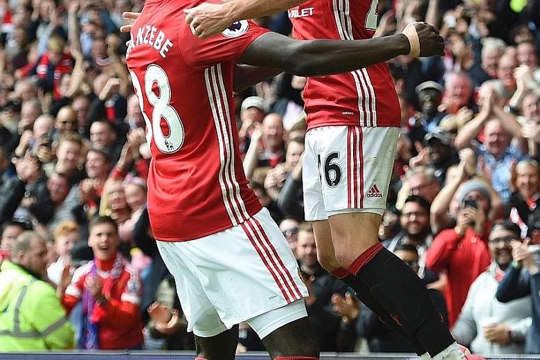 Josh Harrop celebrates scoring on his Manchester United debut against Crystal Palace with Axel Tuanzebe. Harrop, 21, was one of four players Jose Mourinho gave their first starts in a United shirt to.