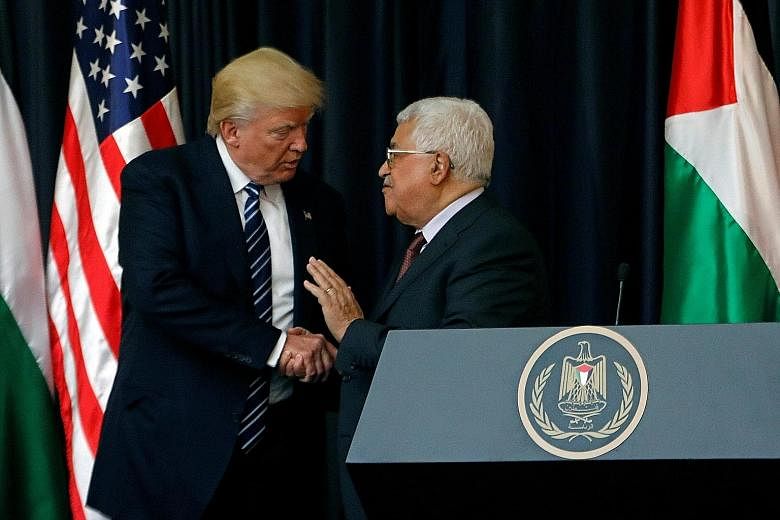US President Donald Trump with Palestinian President Mahmoud Abbas in Bethlehem yesterday. The two men had a private meeting. Israeli Prime Minister Benjamin Netanyahu and Mr Trump chat during their meeting in Jerusalem yesterday. With them was White