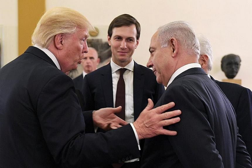 US President Donald Trump with Palestinian President Mahmoud Abbas in Bethlehem yesterday. The two men had a private meeting. Israeli Prime Minister Benjamin Netanyahu and Mr Trump chat during their meeting in Jerusalem yesterday. With them was White