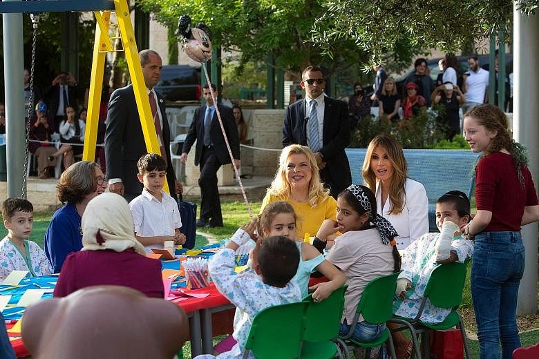 US First Lady Melania Trump (in white) and Mrs Sara Netanyahu, wife of Israeli Prime Minister Benjamin Netanyahu, at the Hadassah Children's Hospital in Jerusalem on Monday.