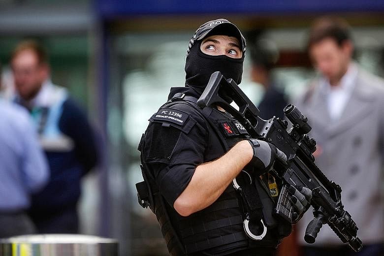An armed officer patrolling Manchester Piccadilly railway station on Tuesday after a terror attack the night before at a pop concert left at least 22 dead.