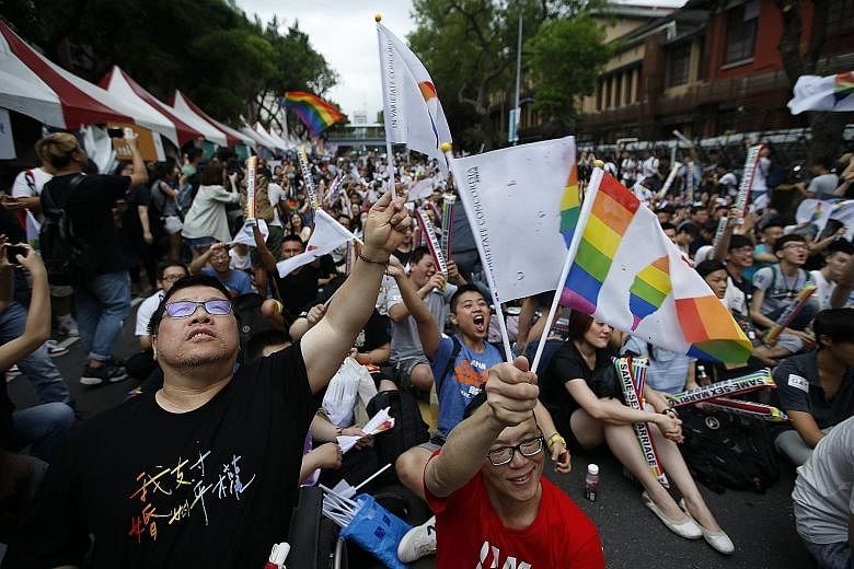 Supporters of same-sex marriage celebrating yesterday outside the Parliament building in Taipei. The Constitutional Court ruled that the island's civil law, which defines marriage as a union between a man and a woman, violates constitutional guarante