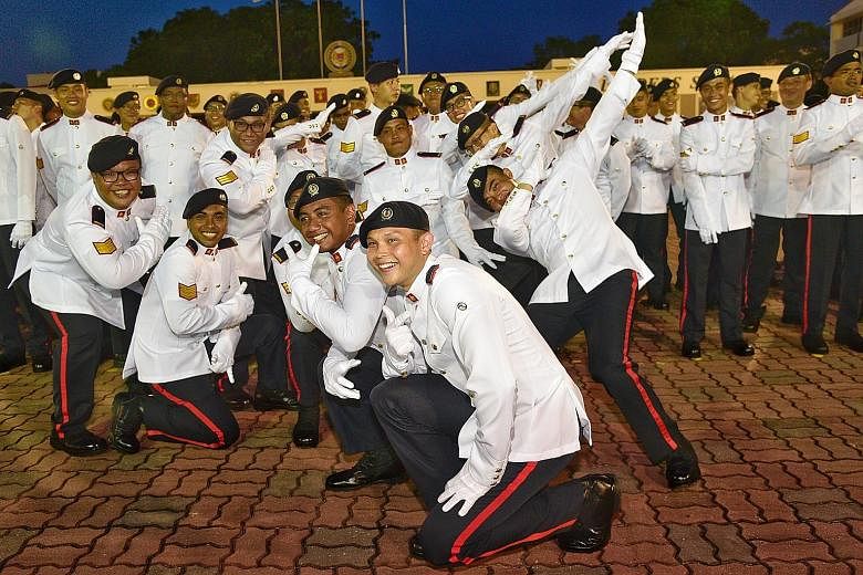 3SG Kyle Brendan Coughlan (front) with fellow graduates at the parade marking the completion of the 22-week combat and leadership course to become SAF specialists yesterday. He was one of 21 who received the highest Distinguished Honour Graduate awar