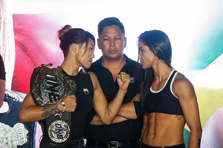 With her championship belt slung over her shoulder, Angela Lee (left) faces off against Istela Nunes (right). Lee said her talent as a fast starter will be crucial in winning today.