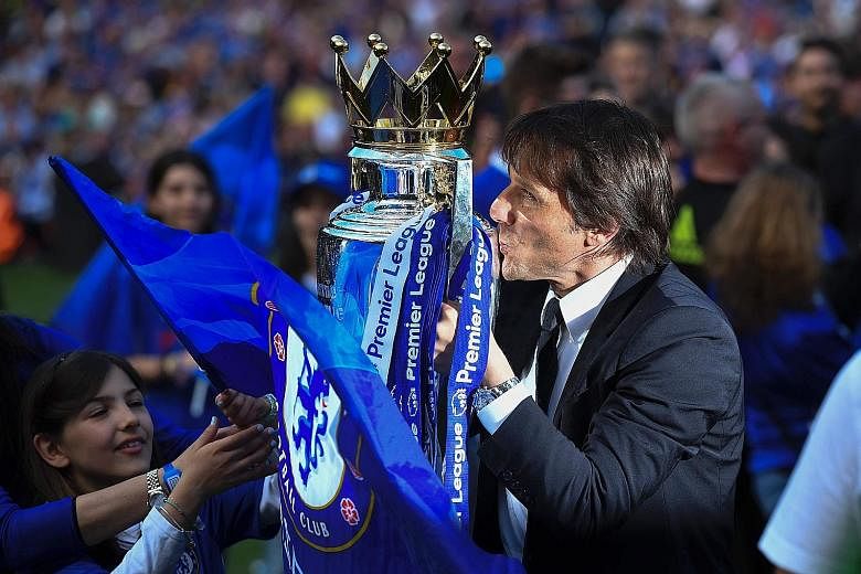 Antonio Conte celebrating capturing the Premier League trophy with Chelsea in his first season in charge. The Italian will attempt to complete a league and Cup double when his side take on Arsenal at Wembley.