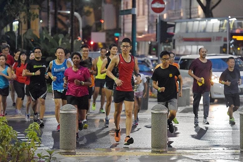 Participants at yesterday's Sunset Run crossing the road to the end point. The ST Run build-up event was followed by dinner at SMU's alumni-run B3 Burger Beer Bistro.