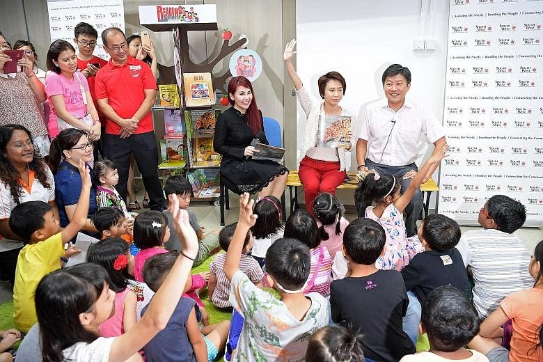 Education Minister (Schools) Ng Chee Meng with (seated from left) South West CDC Family and Active Ageing Functional Committee vice-chairman Jenny Wee and South West District Mayor Low Yen Ling entertaining children at a story-telling session at yest