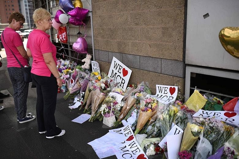 Messages of support and floral tributes to the victims of the attack outside the Manchester Arena Complex. The city's residents showed resilience and community spirit as they comforted one another.